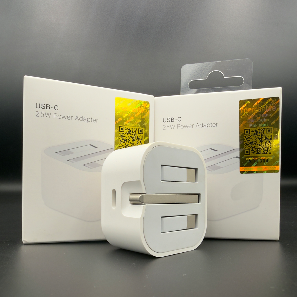 White USB-C power adapter with its packaging on a dark background